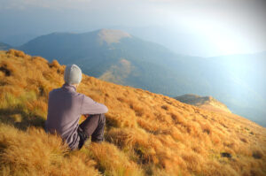 Autumn Landscape with a man sitting on the hillside. Ready for a change.
